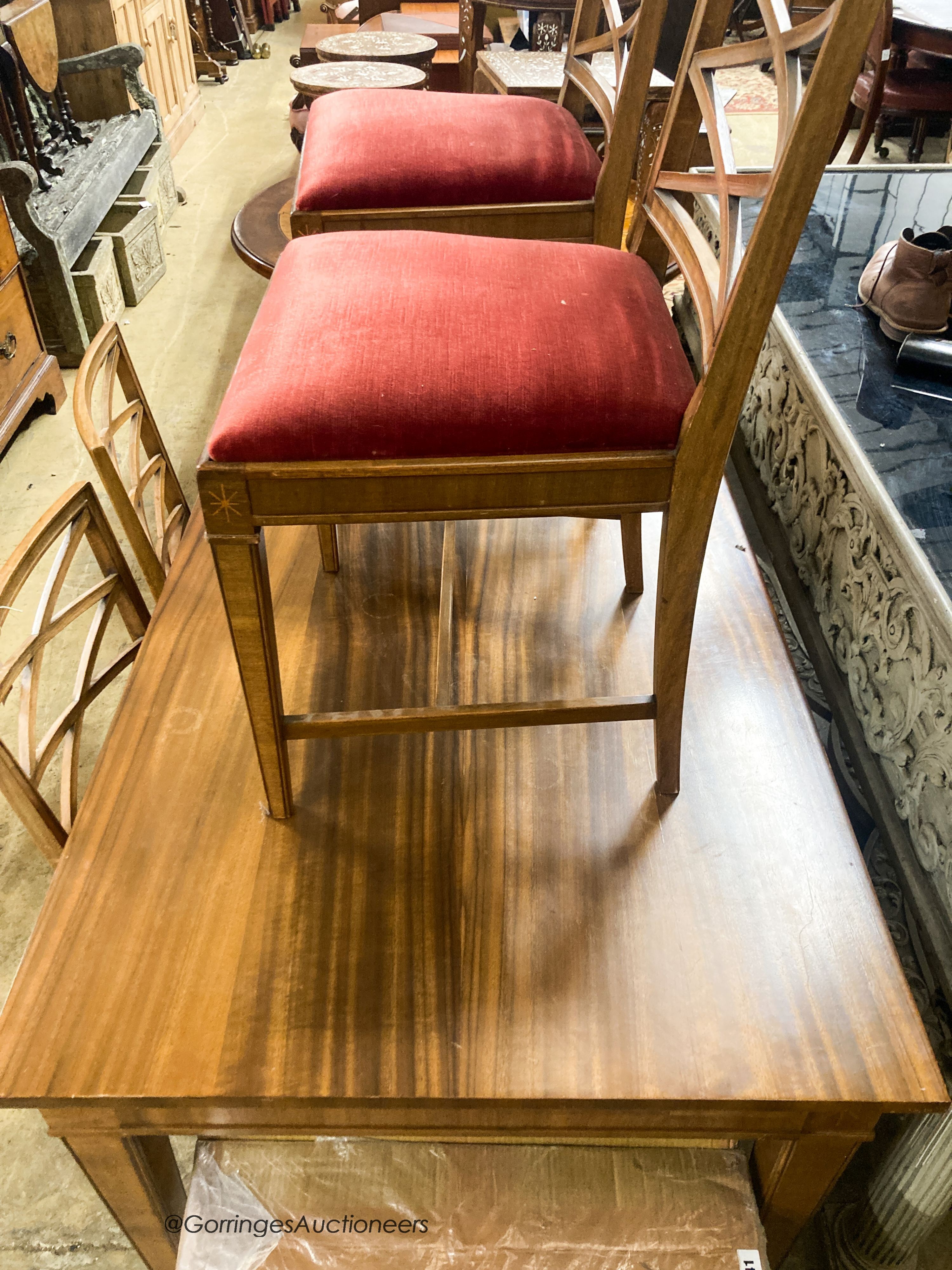 A Swedish walnut and beech dining suite comprising rectangular table. 200cm extended (two spare leaves) and four lattice back chairs with upholstered drop in seats